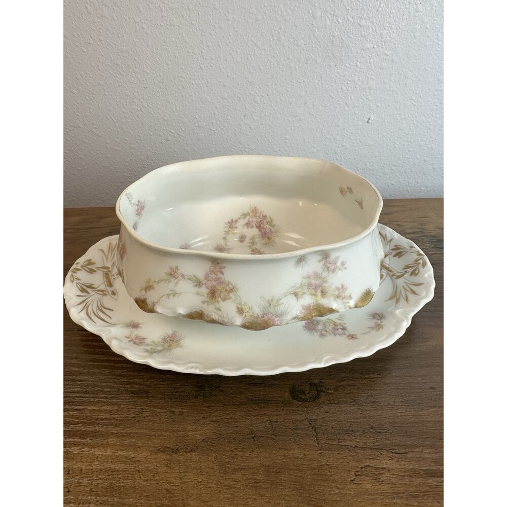 Antique Haviland Limoges gravy boat with underplate. Floral gold trim.